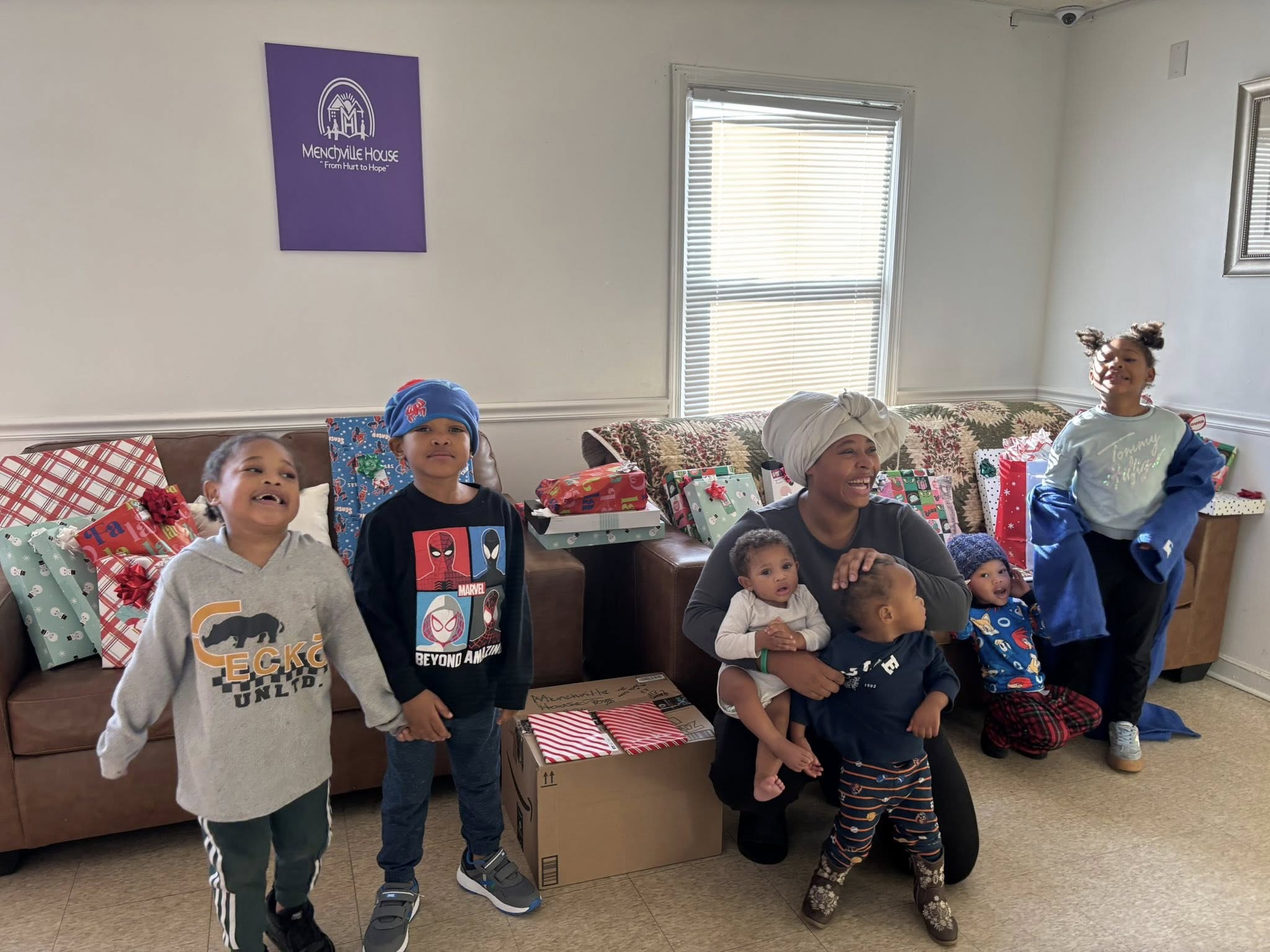 Donors standing beside household cleaning supplies