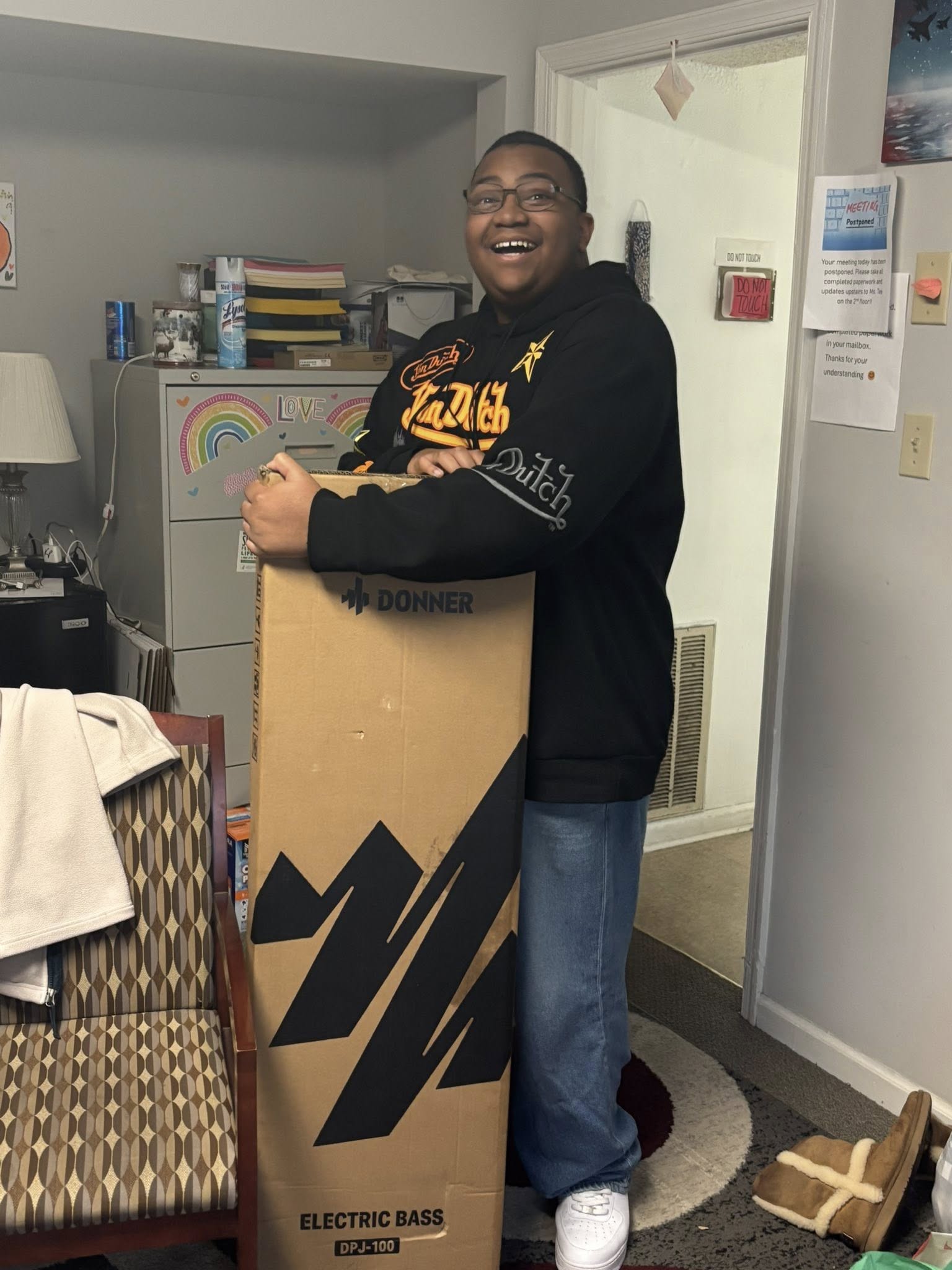 Teen smiling while holding a donated box