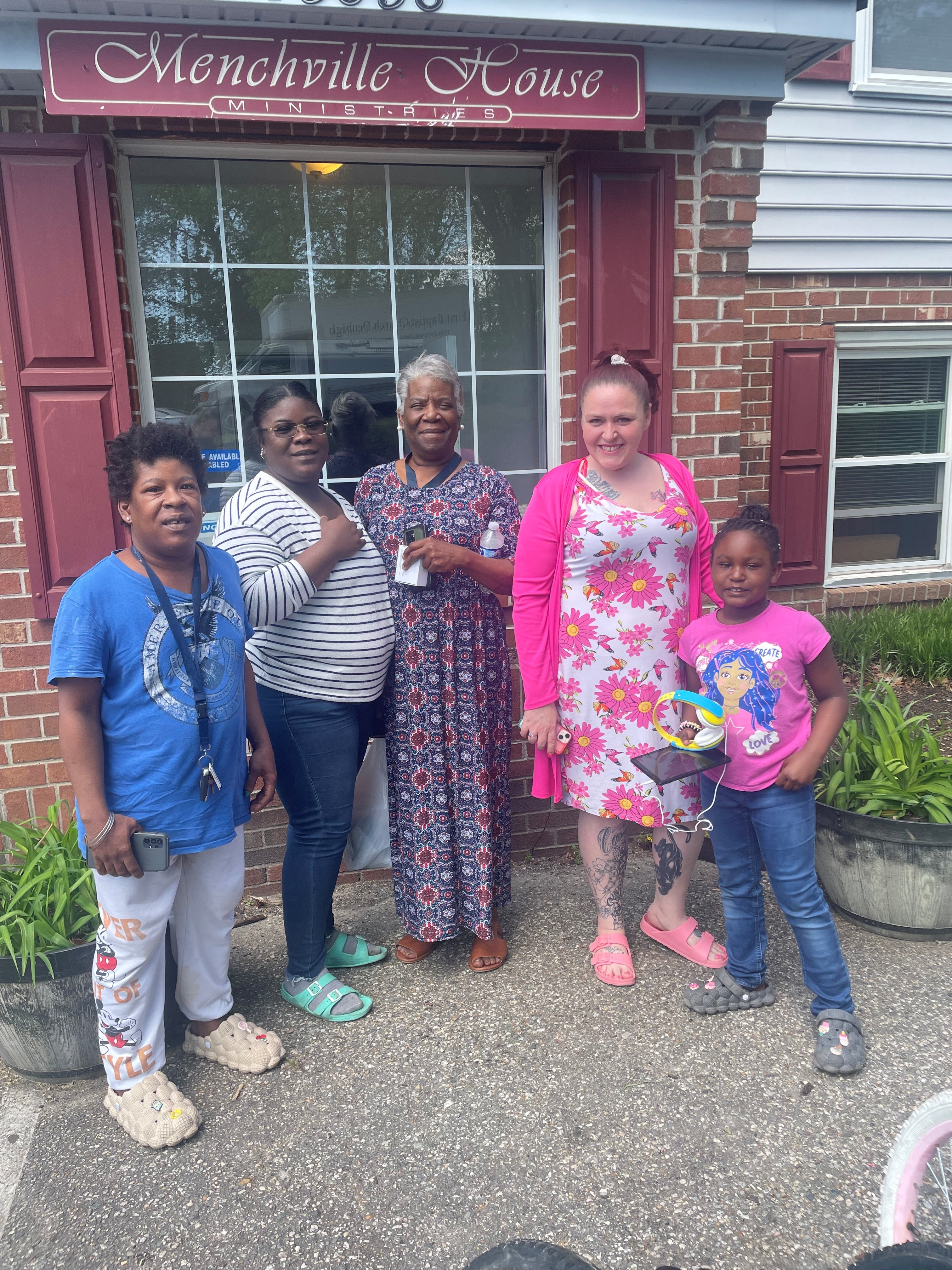 Group standing outside Menchville House